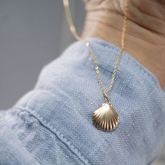 A treasure of the sea, this beautifully crafted 14kt Sea Shell Charm is one of our favorites. A great gift for that ocean loving beauty, shop the Fine Chain and all of their lengths for the perfect set! Size: 11x13mm Material: 14kt Gold Clam, 14/20 Gold Filled Oval Jump-Ring Gold Ocean-inspired Pendant Jewelry, Ocean-inspired Gold Pendant Jewelry, Ocean-inspired Shell-shaped Jewelry Gift, Ocean-inspired Gold Sterling Silver Jewelry, Elegant Shell Jewelry With Lobster Clasp, Elegant Shell-shaped Jewelry With Lobster Clasp, Yellow Gold Shell Jewelry For Beach, Yellow Gold Pendant Jewelry For The Beach, Gold Sterling Silver Jewelry For Beach