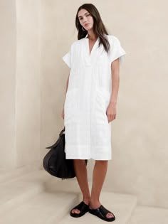 Effortlessly at-ease, we cut this shift dress from a beautiful blend of certified European linen and cotton—one we love for its lived-in look and ability to stay cool and crisp, even in heat and humidity.  Relaxed fit.  V-neck.  Pull-on design.  Side pockets.  Fully lined.  Relaxed fit.  Short sleeves.  Knee length.  Model: Size S, 5'10" (178cm). Utility Dress, Catherine Mcneil, Short Sleeve Midi Dress, Inspiration Outfit Ideas, Comfy Dresses, Midi Short Sleeve Dress, Linen Shop, Casual Stylish, Sleeve Midi Dress