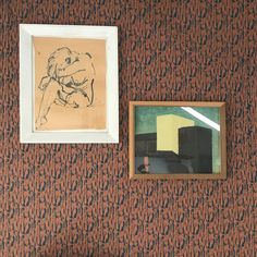 two framed pictures hang on the wall next to a painting and a small drawing in a frame