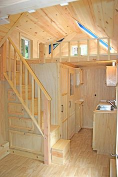 the interior of a tiny house with stairs