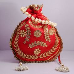 "Traditional India Handcrafted Gota Patti Work Potli Bag Golden Lace Embroidered Handbag For Wedding Bridal Bag Material:Golden Lace, Silk Fabric, Golden Thread, Motifs Color: Red, Pink, Gazri, Navy Blue Package Contents: As per quantity purchased Size: 10\" x 8\" Designed with the heart, this beautiful Potli or batawa bag are eye catchy and made of premium material. Key Features: Gota Patti Work This potli is good match with both Indian and western outfits and are superb for wedding and festive Festive Embroidered Rectangular Pouch, Festive Red Shoulder Bag As Gift, Red Shoulder Bag For Festive Gift, Festive Red Shoulder Bag For Gifts, Traditional Bags With Resham Embroidery, Embroidered Rectangular Festive Pouch, Festive Rectangular Embroidered Pouch, Handwork Red Shoulder Bag As Gift, Festive Red Embroidered Pouch