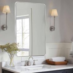 a bathroom sink with a large mirror above it