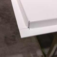 the edge of a white table that is missing