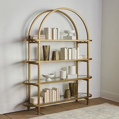 a gold book shelf with books on it