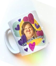 a coffee mug with an image of a woman's face and hearts on it