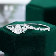 a diamond ring sitting on top of a velvet box