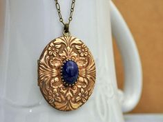 Beautiful vintage American made 70s brass locket decorated with vintage 1950s faux blue lapis glass cab sets in center. Limited stock vintage American made 70s brass locket, other lockets shown in last picture are listed separately in my shop here, https://www.etsy.com/shop/junesnight?ref=condensed_trust_header_title_sold&section_id=6510070 Measurement: Lockets is about 1.7 inch (43mm) in length and 1.35 (33mm) wide, it hangs on 18 inch antiqued brass chain with lobster clasp as shown or sim Vintage Brass Locket Necklace Nickel Free, Blue Antique Finish Jewelry For Gift, Handmade Antique Gold Brass Locket Necklace, Blue Antique Finish Jewelry Gift, Vintage Antique Gold Cabochon Jewelry, Vintage Brass Locket Jewelry, Antique Blue Brass Jewelry, Brass Medallion Jewelry With Cabochon, Blue Antique Jewelry With Antique Finish