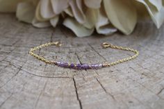 Beautiful crystals are combined with a dainty chain to create this beautiful bracelet.  Amethyst has been renowned for its beauty throughout the ages and is also the birthstone for anyone born in the month of February. D E T A I L S  *It features micro- faceted  shaded amethyst gemstones - separated by seamless gold filled/sterling silver beads. *Beads measure around 2.75mm and originate from Brazil. *Choose between and 18k gold filled chain, rose gold filled or 925 sterling silver chain. *Gold filled is a wonderful alternative to solid gold and unlike gold plating does not rub off. *It closes with a hall marked gold filled/sterling silver spring clasp. *Bracelet comes care instructions and a matching crystal information card and is ready for gifting. S I Z I N G * H E L P Choose the lengt Dainty Amethyst Jewelry With Adjustable Chain, Elegant Purple Birthstone Beaded Bracelets, Dainty Amethyst Bracelet Jewelry, Dainty Amethyst Jewelry With Delicate Chain, Dainty Faceted Amethyst Jewelry, Dainty Gold Amethyst Bracelets, Dainty Amethyst Bracelets For Gift, Dainty Purple Gemstone Bracelets, Delicate Purple Jewelry For Everyday Wear