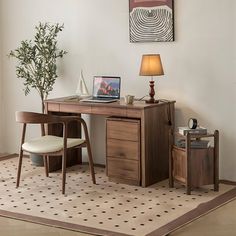 a wooden desk with a laptop on top of it next to a chair and lamp