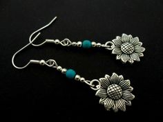 This a pair of pretty tibetan silver dangly sunflower earrings. Measure approx. 4cm from top of hook to bottom of earring. Freshly made by me and unworn. Thanks for looking!! Bohemian Sunflower Drop Earrings, Adjustable Silver Bohemian Flower Earrings, Turquoise Flower Charm Dangle Jewelry, Turquoise Dangle Jewelry With Flower Charm, Adjustable Sunflower Design Dangle Jewelry, Adjustable Sunflower Dangle Jewelry, Bohemian Silver Earrings With Flower Charm, Adjustable Dangle Earrings With Flower Charm, Bohemian Adjustable Sterling Silver Flower Earrings