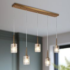 three lights hanging from a wooden beam in a room