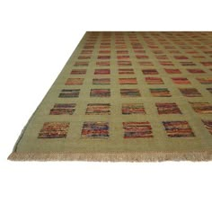 an area rug with different colored squares and fringes on the bottom, along with a white background