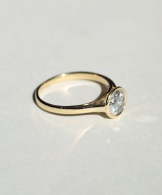 If in stock, custom sized in 1-2 weeks. A Salt & Pepper diamond in a high bezel setting revealing the side profile of the ring Specifications: 1ct round double cut salt and pepper diamond, in a high bezel setting, 14k yellow or white gold Classic 14k Gold Ring With Bezel Setting, Classic Moissanite Ring With Bezel Setting, Elegant Round Diamond Ring With Smooth Bezel, Heirloom Moissanite Ring With Bezel Setting, Moissanite Yellow Gold Rings With Bezel Setting, Classic Single Diamond Ring For Everyday, Minimalist Marquise Cut Bezel Set Jewelry, Classic Everyday Diamond Ring With Single Diamond, Minimalist Marquise Cut Jewelry With Bezel Setting