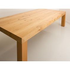 a wooden table sitting on top of a white floor