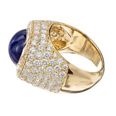 For Sale on 1stDibs - David Webb Mid-Century sapphire and diamond cocktail ring. GIA certified 14.4 carat oval cabochon center stone with 134 round brilliant cut accent diamonds. Luxury Oval Sapphire Ring With Pave Setting, Luxury Sapphire Diamond Ring With Polished Finish, Yellow Gold Sapphire Ring With Diamond Oval Cabochon, Yellow Gold Sapphire Diamond Ring With Oval Cabochon, Oval Cabochon Sapphire Ring In Yellow Gold With Diamond, Oval Cabochon Diamond Ring, Luxury Oval Dome Ring With Pave Setting, Luxury Diamond Oval Cabochon Ring, Luxury Round Cabochon Diamond Ring