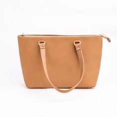 Upgrade your experience with our Leather Tote Bag in French beige. This bag is best for daily use, as it is easy to carry. Made of Cowhide leather, this bag lasts longer than ordinary tote bags and offers a touch of sophistication. You can wear its soft leather straps over your shoulder, keeping all your necessary items with you. This leather tote bag has a sleek, elegant design. It makes any regular outfit unique. This fascinating design and a good space make it the best bag for women's daily u Outfits Unique, Leather Tote Bag Women, Best Bags, Leather Tote Bag, Cowhide Leather, Leather Tote, Soft Leather, Elegant Design, Leather Women