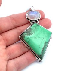 This large, kite shaped apple green variscite and rainbow moonstone pendant is set bezel set in sterling silver. Wear on a chain, leather or satin cord. If you  like large unique jewelry,  this is perfect for you! Metal Content: Sterling Silver -tested Measurements Length including bail:  3 1/8" (80mm) Width:  1 5/8" (41mm) Bail opening: 12mm x 6mm Weight: 25 Grams Stamps: none noted Condition: Excellent Pre-Owned Items will ship in a gift box or pouch Each piece is thoroughly examined and refin Artisan Jewelry With Large Chrysoprase Stone, Chrysoprase Jewelry With Large Stone For Gift, Green Rectangular Artisan Jewelry, Artisan Rectangular Green Jewelry, Artisan Green Rectangular Jewelry, Chrysoprase Gemstone Dangle Jewelry, Nickel-free Chrysoprase Jewelry Gift, Bohemian Jewelry With Rectangular Gemstone Pendant, Green Moonstone Jewelry With Natural Stones