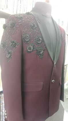 Unveil the embodiment of sophistication with our handmade embroidered designer suit jacket for men, where every stitch tells a story of master craftsmanship. This custom-designed floral blazer is the ideal choice for party, staying impeccably dressed at formal engagements, weddings, and a myriad of special events. Crafted with precision, its rich burgundy fabric seamlessly pairs with intricate black embroidery, making it a striking addition to any distinguished collection. The satin lapel enhances its elegance, ensuring you captivate attention effortlessly. Available across a diverse range of sizes, this blazer can be perfectly tailored to suit your bespoke measurements. Gift him or Elevate your style and shop today for this extraordinary piece of formal wear set.  Key Features: - Handmade Embroidered Fitted Suits For Ceremonial Occasions, Ceremonial Embroidered Fitted Blazer, Luxury Formal Blazer With Floral Embroidery, Luxury Floral Embroidery Blazer For Formal Occasions, Luxury Floral Embroidery Formal Blazer, Ceremonial Fitted Suit With Resham Embroidery, Fitted Suits With Resham Embroidery For Ceremonial Occasions, Traditional Tailored Embroidered Suits, Designer Embroidered Tailored Suits