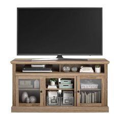 a flat screen tv sitting on top of a wooden entertainment center