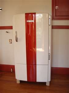 a red and white refrigerator in a kitchen