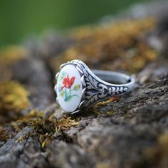 Victorian style German Tulip Cameo. Available on an antiqued brass or silver vintage ring. I do not recommend that this be worn while bathing or swimming although normal handwashing is fine. Vintage Silver Nickel-free Flower Ring, Handmade Antique Silver Vintage Rings, Vintage Oval Enamel Jewelry, Handmade Vintage Antique Silver Rings, Retro Handmade Oval Jewelry, Vintage Brass Cabochon Rings, Vintage Adjustable White Flower Ring, Vintage Oval Flower Ring, Vintage Sterling Silver Flower Ring Gift