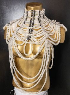 The pearl and rhinestone statement necklace is a stunning piece of jewelry that is sure to make a bold impression. The necklace features a combination of pearls and rhinestones, which create a striking contrast and add a touch of glamour and sophistication to any outfit. It's perfect for formal events and can be worn with a variety of different outfits, from dresses to blouses and even t-shirts. This necklace is truly a statement piece that is sure to turn heads wherever you go! Chic Evening Pearl Necklace, Chic Pearl Necklaces For Party, Party Pearl Necklace With Pearl Pendant, Pearl White Beaded Jewelry, Party Pearl Beaded Necklace With Pearl Pendant, Party Pearl Beaded Necklaces With Pearl Pendant, Party Beaded Pearl Necklaces With Pearl Pendant, Party Pearl Embellished Choker Necklace, Pearl Embellished Choker Necklace For Parties