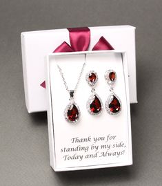 "Burgundy bridesmaid earrings Dark red tear drop earrings Bridesmaid gift bridesmaid necklace bracelet bridesmaid jewelry This set features AAA top burgundy CZ crystal posts matched with bottom tear drop burgundy pendants, and matching necklace and bracelet set. They are in Rose gold, Gold and White gold (silver colored) plated settings, nickel and lead safe, and are tarnish resistant. Earrings measure 1.25 (31mm) inches in lengths.  Clip on earrings for non pierced ears are also available, please leave a note at checkout. Necklace measures 16 inches with extensions adjustable to 18.5 inches. Other lengths are also available at your request.  Burgundy bracelet measures 6.5 -7.5 inches with removeable extender links.  Please leave a note in the \"add a note to seller\" box at checkout for c Red Cubic Zirconia Jewelry For Mother's Day, Mother's Day Red Cubic Zirconia Jewelry, Sterling Silver Jewelry Sets For Wedding On Valentine's Day, Valentine's Day Wedding Jewelry With Matching Earrings, Red Cubic Zirconia Jewelry Gift, Red Teardrop Jewelry For Anniversary, Red Teardrop Necklace For Wedding, Pear-shaped Jewelry For Valentine's Day Gift, Teardrop Pendant Jewelry Sets For Wedding