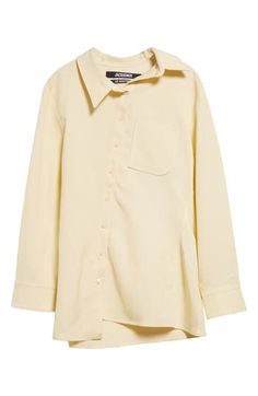 The asymmetric placket of this butter-yellow shirt shifts the collar, J-shaped chest pocket, hem and drape of the back box pleat slightly off-kilter. Asymmetric front-button closure Asymmetric point collar Long sleeves with one-button cuffs Chest patch pocket 88% viscose, 12% polyester Dry clean Imported Designer Clothing Elegant Yellow Collared Blouse, Elegant Yellow Workwear Shirt, Classic Yellow Long Sleeve Blouse, Yellow Spread Collar Shirt For Work, Classic Long Sleeve Yellow Blouse, Elegant Yellow Collared Shirt, Chic Yellow Collared Blouse, Yellow Collared Shirt For Work, Collared Yellow Shirt For Work