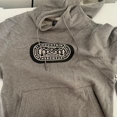 Band New With Tags Mountain Hard Wear Gray Cotton Hoodie With Graphic Print, Casual Sweatshirt For Outdoor Winter Activities, Casual Hooded Sweatshirt For Outdoor, Casual Winter Sweatshirt For Outdoor Activities, Cozy Heather Grey Cotton Hoodie, Casual Fleece Hoodie For Outdoor, Casual Fleece Sweater For Outdoor Activities, Casual Outdoor Fleece Hoodie, Casual Fall Hoodie For Outdoor Activities