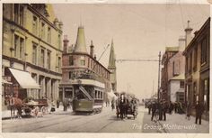 an old photo of a trolley and horse drawn carriages on a street in the city