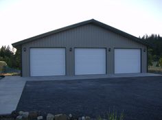 two garages are shown in front of a large driveway with gravel and rocks on the ground