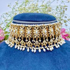 Featuring a classic broad pearl choker necklace matched with a magnificient pair of edwardian era style earrings, made in sterling silver with 22K gold plating. Ideal for wedding functions and will go with any south asian attire. It has been embellished with freshwater pearls. Weight - 110 GMs for the full set with earrings weighing 30gms Default Materials in Our Gold Plated Jewellery Metal: 925 Sterling Silver Studded Stones: Precious freshwater pearls, synthetic red,green,blue stones that rese Elegant Kundan Choker Necklace For Ceremonial Occasion, Elegant Formal Kundan Choker, Elegant Formal Kundan Choker Necklace, Elegant Kundan Choker For Formal Occasions, Elegant Kundan Choker Necklace With Tilla, Elegant Kundan Choker Necklace For Formal Occasions, Formal Bridal Choker With Tilla, Elegant Festive Ceremonial Choker, Elegant Kundan Bridal Choker Necklace