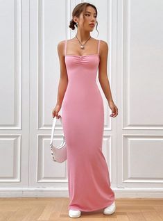 Femininely sculpted, this blush pink maxi dress combines elegance with simplicity, creating a stunning visual harmony. The soft pink hue exudes romance and softness, making it a perfect choice for special occasions that call for a touch of subtlety and grace. The dress features delicate spaghetti straps and a gentle ruching at the bust, enhancing its feminine charm. Its form-fitting silhouette flows seamlessly down to a gently flared hem, crafting a figure that is both flattering and comfortable Feminine Solid Color Maxi Dress For Evening, Pink Solid Color Evening Dress, Feminine Fitted Solid Maxi Dress, Fitted Feminine Solid Maxi Dress, Chic Pink Backless Maxi Dress, Pink Backless Slip Dress For Prom, Elegant Maxi Dress With Spaghetti Straps In Solid Color, Elegant Pink Slip Dress With Spaghetti Straps, Elegant Pink Asymmetrical Maxi Dress