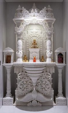 an ornate white fireplace in a room