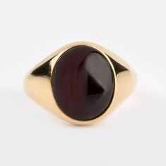 A beautiful Garnet signet ring - Recommended by Etsy! *real images of the ring, taken by us* Garnet Stone Size: 12x10mm Material: - 9K Gold (375) - 14K Gold (585) - 18K Gold (750) *All signet rings are hallmarked on the back for certification* - We offer FREE Worldwide DHL & FedEx Shipping! - Branded DanelianJewelry Gift Box with each order! Our customer service is available 7 days a week. Leave us your message, and we will get back to you within a little time. ✔️ Tracking number ✔️ Worldwide sh Luxury Red Signet Ring With Polished Finish, Modern Oval Cabochon Signet Ring For Formal Occasions, Modern Oval Cabochon Signet Ring For Gift, Modern Oval Cabochon Signet Ring As Gift, Classic Ruby Ring With Polished Finish For Collectors, Classic Open Signet Ring Collectible, Classic Yellow Gold Signet Ring With Cabochon, Oval Cabochon Signet Ring With Polished Finish, Classic Formal Gemstone Signet Ring