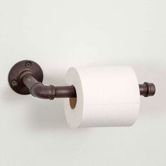 a roll of toilet paper is hanging on the wall