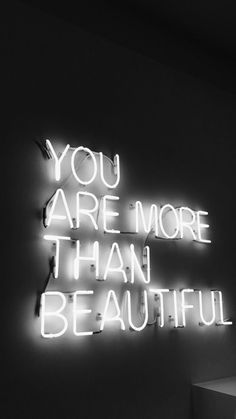 a neon sign that says you are more than beautiful