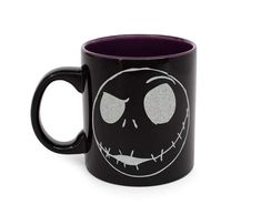 a black and purple coffee mug with the face of jack skellingy on it