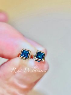 Princess cut blue sapphire bezel set stud 14k white earrings. Minimalist design earrings with deep rich blue tones. Sapphire is birthstone to September and holds great jewelry history. Each is bezel set in solid 14k white with 0.38 carat, 3.00mm square shape step cut sapphire. Center post allows these to be worn square or rotate in a diamond shape. Ready to ship. Blue Bezel Set Earrings For Formal Occasions, Blue 14k Gold Jewelry With Tension Setting, Sapphire Jewelry With Bezel Setting For Anniversary, Modern 14k White Gold Jewelry With Bezel Setting, Anniversary Sapphire Jewelry With Bezel Setting, Blue Bezel Set Jewelry For Anniversary, Silver 14k Gold Birthstone Earrings, 14k Gold Silver Birthstone Earrings, Classic Sapphire Jewelry With Bezel Setting