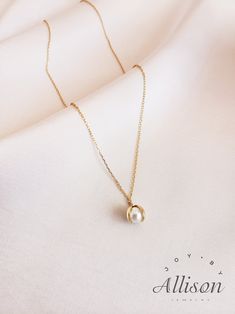 Pearls are used a lot in accessories as gemstones. It looks classy, timeless and elegant, and we agree! However, we try to bring pearl necklaces to a whole new level. Here we present you a necklace with a pendant you've never seen before. Our pendant shows a shell that is opened with a beautiful pearl inside. This is truly a one-of-a-kind piece.  This beautiful necklace is made of 925 sterling silver that is plated with 18K gold. The star of the pendant is a real, freshwater pearl. The length of the necklace is 40 cm while the pendant's length is 2.2 cm. Our jewelry comes with a pouch for safekeeping. A wonderful gift option for a lover, mother, or daughter. Show how much you care by giving them this amazing necklace. A beautiful piece to symbolize beauty, elegance, and class. Suitable for Simple Everyday Jewelry With Pearl Charm, Pearl Clavicle Chain Jewelry For Gift, Elegant Teardrop Pendant Pearl Necklace, Elegant Charm Necklace With Delicate Chain For Everyday, Elegant Everyday Pendant Charm Necklaces, Delicate Pearl Charm Jewelry Gift For Her, Round Drop Necklace With Delicate Chain For Gift, Delicate Clavicle Chain With Round Pendant, 14k Gold-filled Round Pearl Pendant Jewelry