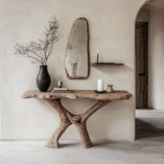 a wooden table sitting in front of a mirror