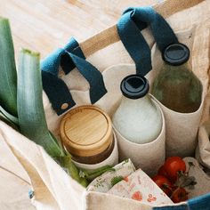 a bag filled with bottles and vegetables on top of a table