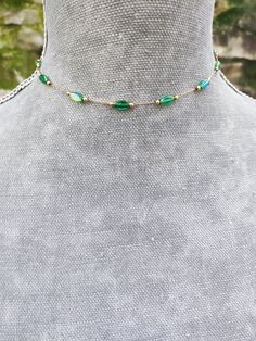 Super dainty emerald green crystal beaded choker made of gold plated stainless steel and beautiful little long ab green crystals. PLEASE read my shop announcement before placing an order so you know what to expect right now. Plus, when ordering from outside Europe, don't forget to provide a phone number for the courier to ensure the fastest and smoothest delivery Stainless steel chain and findings, won't rust or anything  Fastens with a solid lobster clasp, and has an extension chain.   Choker is 13 inches long and comes with an extension chain, but I can make it in your desired length, just ask me. ✨ Another super dainty double chain choker here: https://www.etsy.com/listing/1684657649/dainty-satellite-chain-choker-necklace All my jewelry is nickel and lead free.  I'm so sorry for having Green Dainty Clavicle Chain Necklace, Beaded Chain Choker Jewelry As Gift, Wire Wrapped Choker For Party, Green Delicate Chain Jewelry For May Birthstone, Handmade Dainty Choker Chain Necklace, Dainty Green Jewelry With Delicate Chain, Green Emerald Jewelry With Delicate Chain, Dainty Handmade Choker Chain Necklace, Gold Emerald Jewelry With Delicate Chain