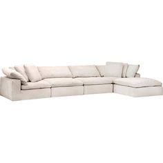 a white sectional couch with pillows on it's back and the seat folded out