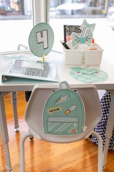 a child's table and chair with various items on it