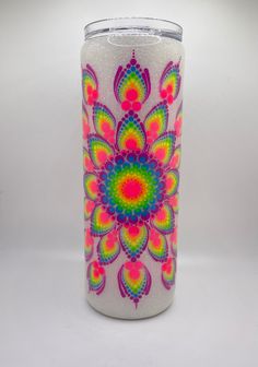 a colorful glass with a flower design on it