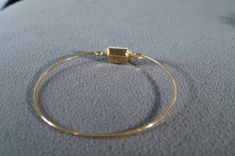 I am offering this fabulous vintage bracelet. This piece is truly gorgeous, and it has the following features: * beautiful vintage bracelet * yellow gold tone * square * glass stone * bangle * 2.5 inches in width This is a fantastic and classic piece. There is tons of sparkle and shine with this piece. It will beautifully complement your upcoming fashion season. Buyer pays all shipping and handling Vintage Gold Bangle With Gemstone, Gold Jewelry With Rectangular Stone For Wedding, Vintage Stackable Bracelet Jewelry, Vintage Gold Stackable Bracelets, Adjustable Gold Jewelry With Rectangular Stone, Adjustable Square Gold Bracelet, Adjustable Gold Bangle With Jewels, Vintage Jewelry With Gold Rectangular Stone, Gold Rectangular Bangle Gift