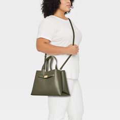 Flaunt a classic look as you head out to the office or a brunch date by carrying the Belted Satchel Handbag from A New Day™. This satchel handbag includes multiple compartments along with an interior zip pocket to offer plenty of space for your cosmetics, phone and other belongings. It showcases a structured silhouette with belted detailing on the front for sleek style, and it pairs well with a variety of outfits. Plus, you can carry it multiple ways using the double handles and adjustable, deta Office Handheld Satchel With Removable Pouch, Classic Green Satchel For On-the-go, Green Office Bag With Detachable Handle, Green Office Bags With Detachable Handle, Versatile Handheld Satchel For Office, Green Shoulder Bag For Work, Office Satchel With Top Handle And Removable Pouch, Casual Office Satchel With Adjustable Strap, Chic Green Office Bags