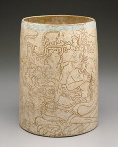 a ceramic cup with designs on it