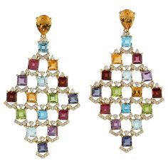 These multi gemstone earrings are handmade in 18 Karat gold. It is beautifully detailed with 19.95 carats amethyst, citrine, garnet, peridot, topaz and 1.39 carats of sparkling diamonds. FOLLOW MEGHNA JEWELS storefront to view the latest collection & exclusive pieces. Meghna Jewels is proudly rated as a Top Seller on 1stDibs with 5 star customer reviews. All items manufactured by us are handmade and can be customized or redesigned. Composition Size-57X30 MM Total Weight-22.81 Gold Weight(Gms)-19 Luxury Multi-stone Fine Jewelry Earrings, Luxury Multicolor Earrings With Gemstone Accents, Multicolor Gemstone Accented Earrings For Formal Occasions, Formal Multicolor Gemstone Earrings, Premium Jewelry, Diamond Dangle Earrings, Art Deco Diamond, Blake Lively, Top Seller